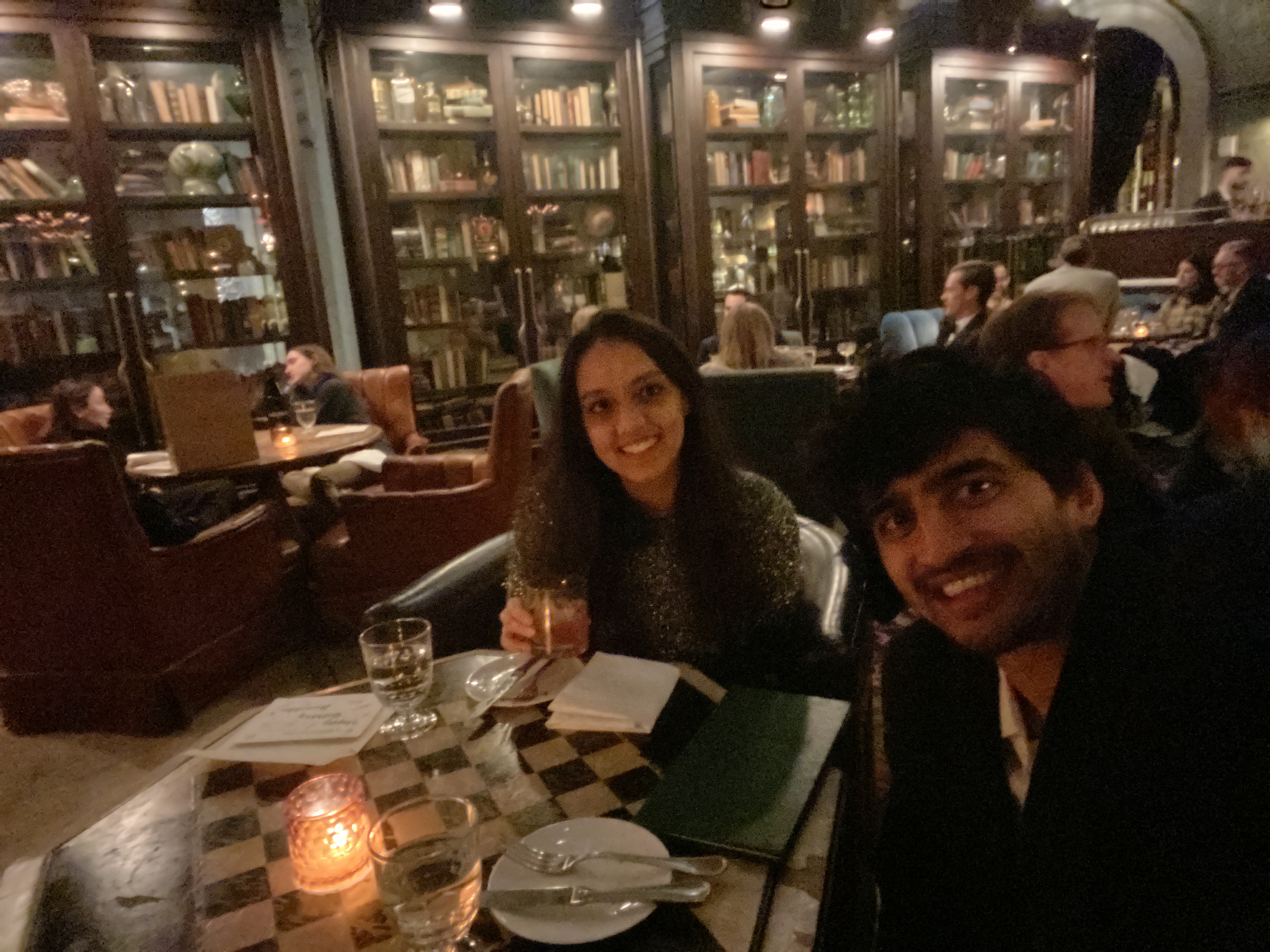 Candlelit dinner in The Beekman's library restaurant with floor-to-ceiling bookshelves